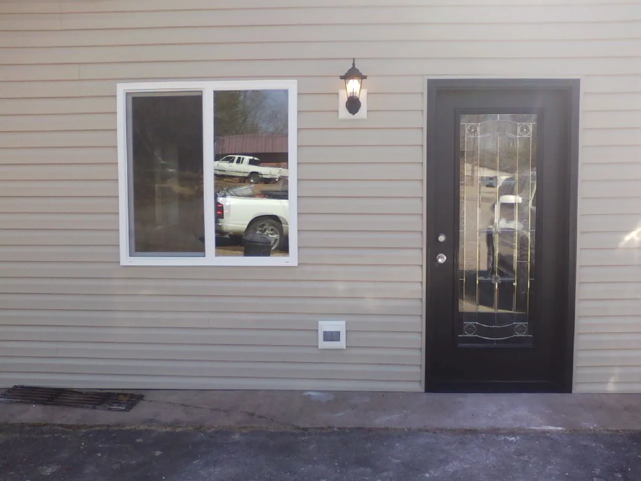 New siding, window and entry door on the side of an addition in Rebersburg