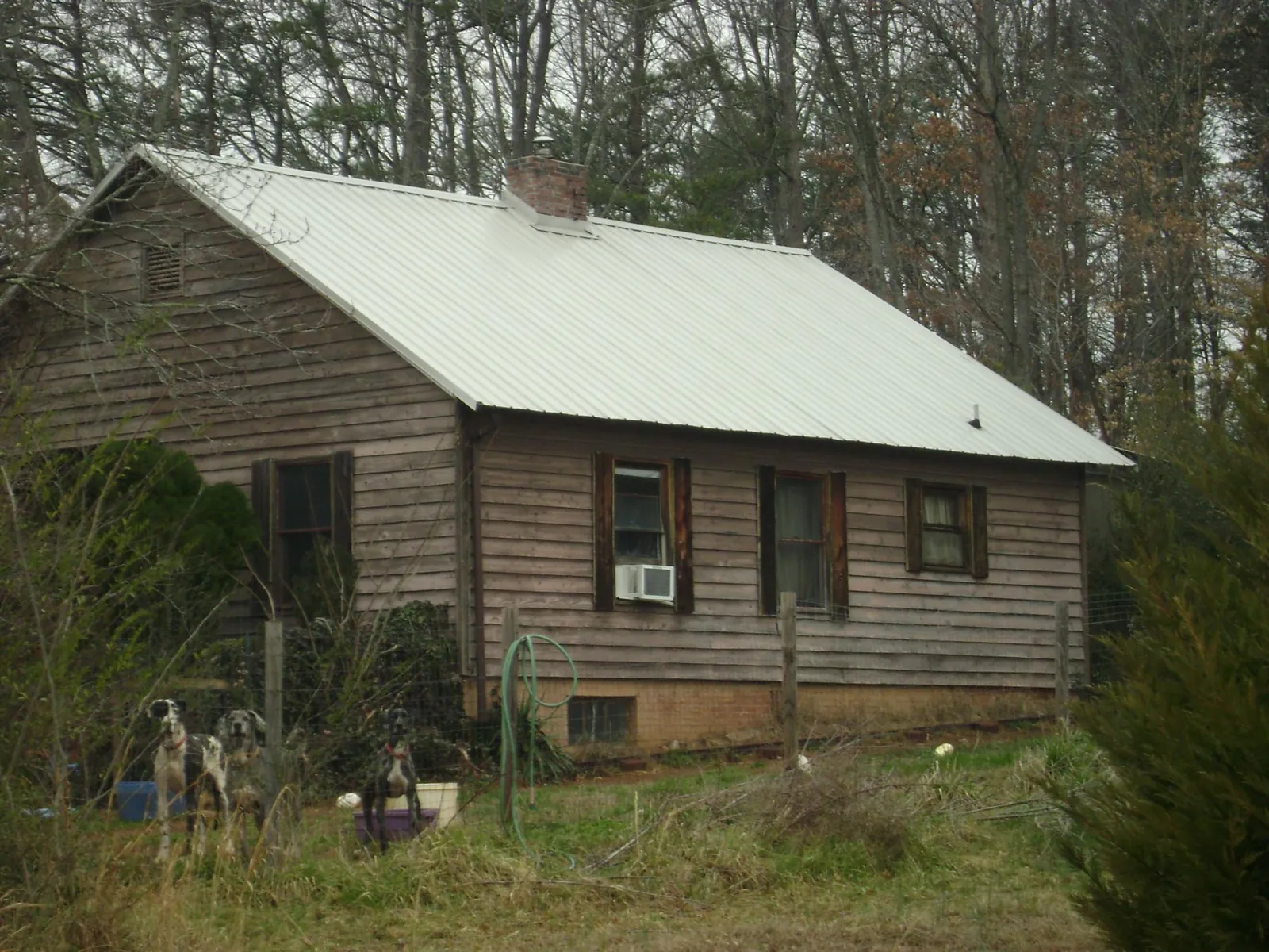 White metal roof on an old wood sided farmhouse, from a Metal Roof Installation job in Rebersburg